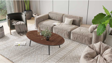 An interior visualization of a living room seating area with a gray sofa bed and a matching lazy bag, and a brown rounded coffee table.